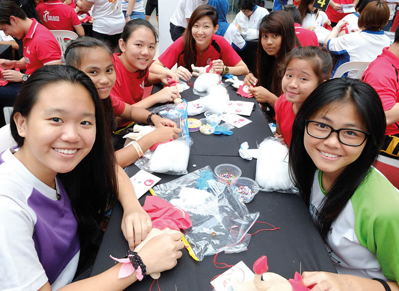 Volunteers, including students and families, helped to sew and stuff thousands of NILA plush toys.
