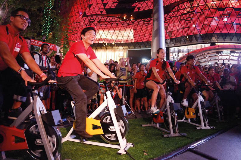 Minister for Culture, Community and Youth Lawrence Wong and national athletes cycled to light up the SEA Games Arch at the 3-month countdown.