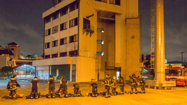 SCDF volunteer trainee firefighters prepare to enter The Furnace, a building that can simulate 14 types of fire settings for different spaces.