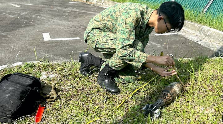An NSF from the EOD unit measuring an unexploded ordnance as part of training.