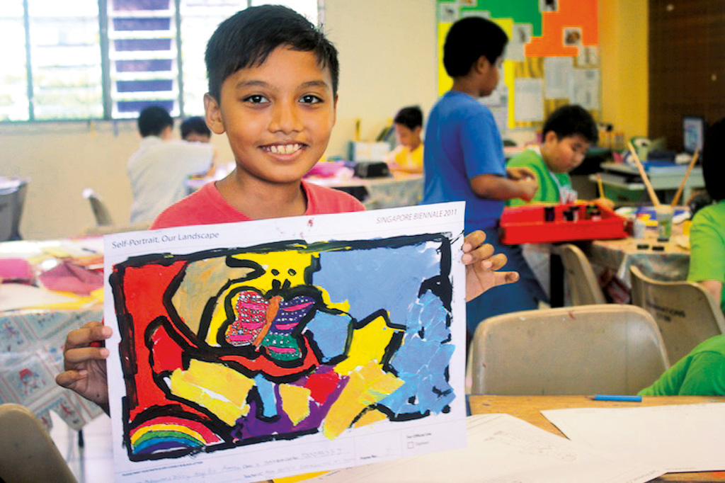 young boy with his artwork